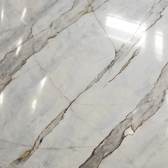 A polished Calacatta Borghini sample board, white with bold gray and ochre veins, the room’s lights reflected in its shine
