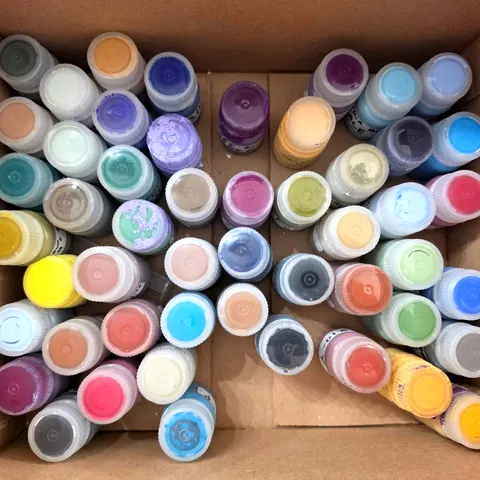 A box of color bottles from our working library, seen from above, in every hue from yellow to violet