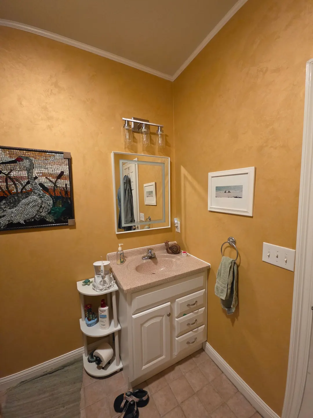 Golden, textured walls with a soft sheen around a white vanity, in a Zionsville powder room